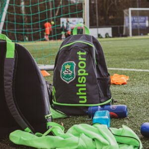 black and orange backpack on green grass field